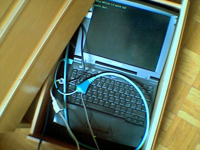 An open laptop sitting in a drawer